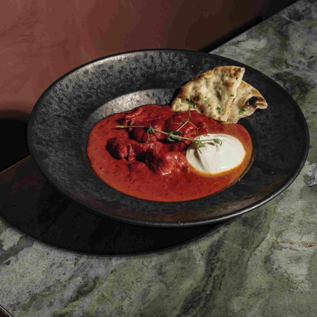 Fusion curry topped with burrata and served with naan bread at Ruby Rays Indian Restaurant Malta