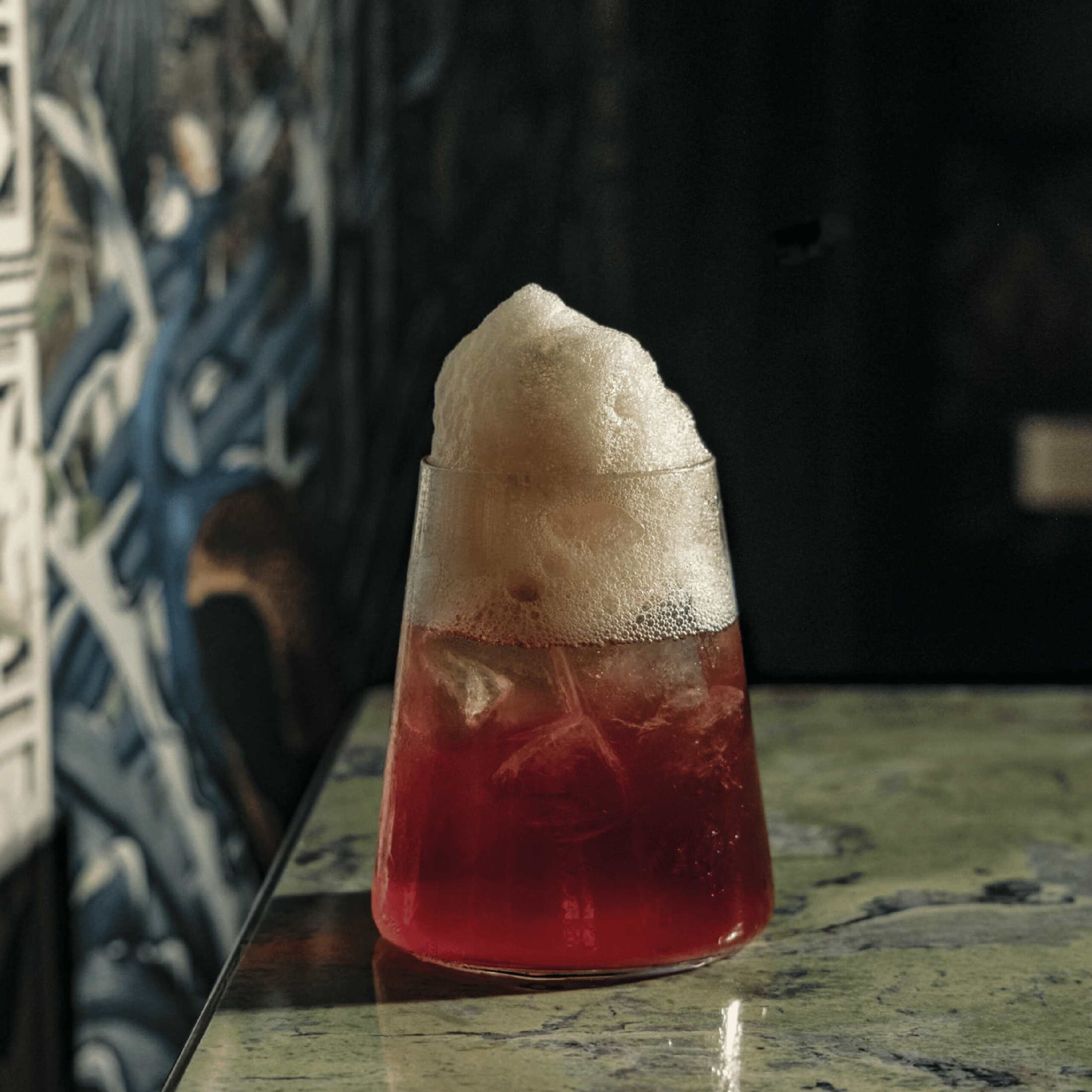 Foam-topped signature cocktail served at Ruby Rays Indian fusion bar in St. Julian’s, Malta