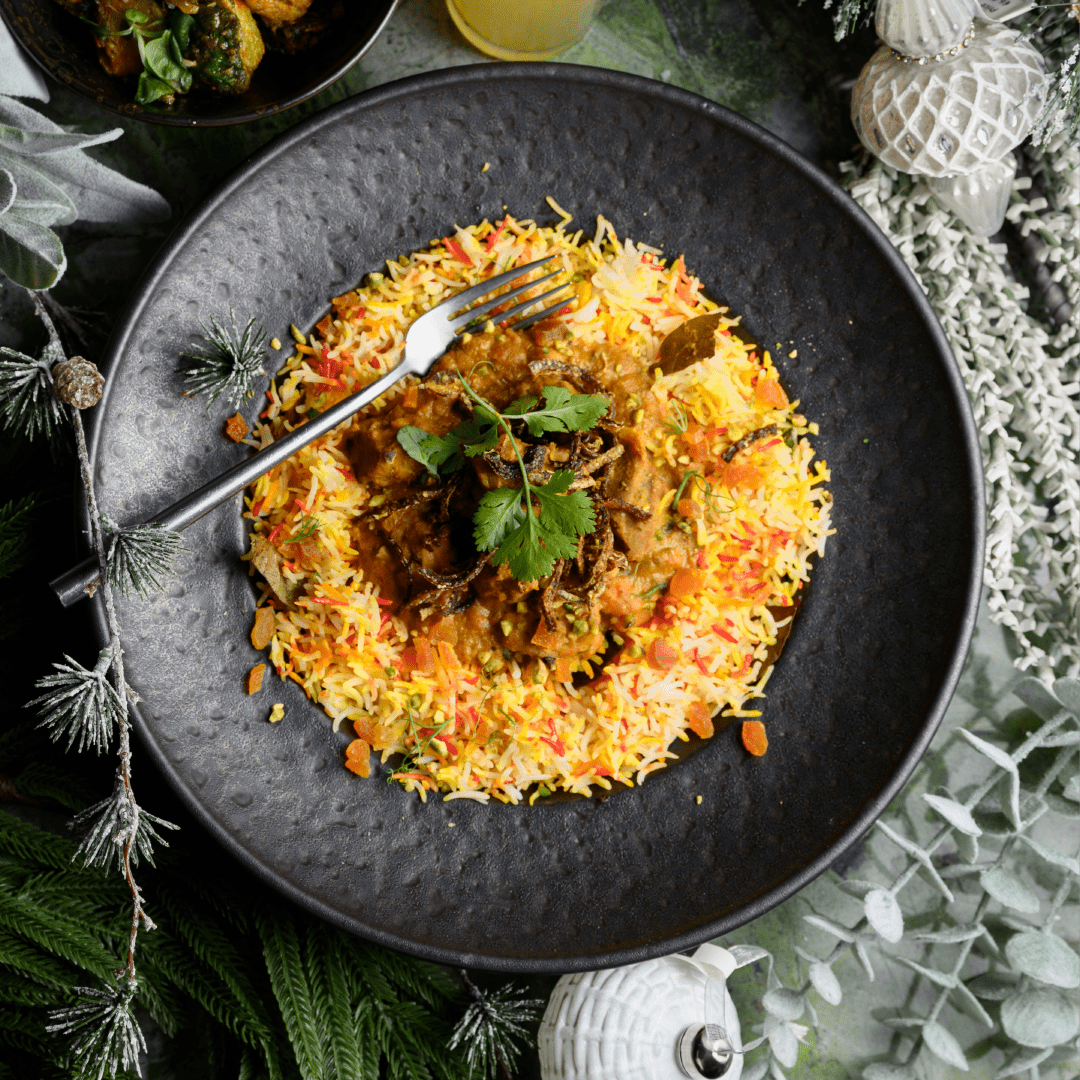 Festive rice and meat dish at Ruby Rays Malta featuring aromatic spices, colourful plating, and elegant presentation.