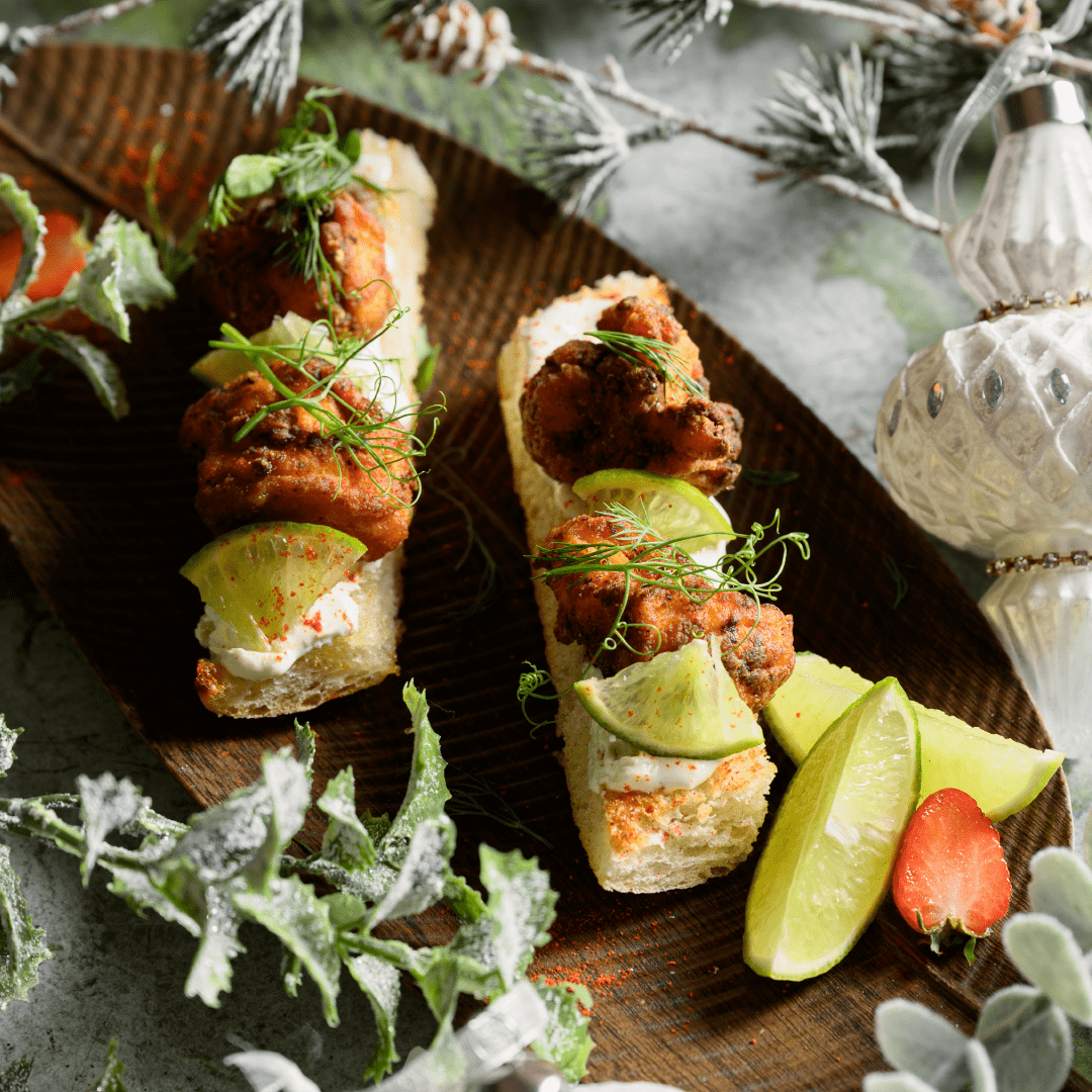 Salmon crostini festive starter at Ruby Rays Malta topped with fresh herbs and served on a marble table.